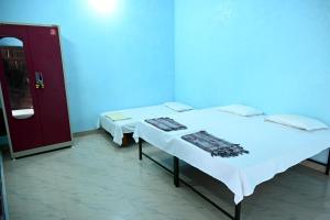 Voodi või voodid majutusasutuse Sandhya Guest House toas