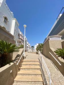 a set of stairs leading up to some buildings at Apartamento Atlántico in Rota
