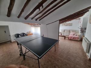 a ping pong table in the middle of a living room at Casa Arriba Village House in Zarra in Zarra
