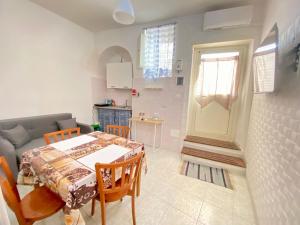 a kitchen and dining room with a table and a couch at Bentivegna Apartments in Syracuse