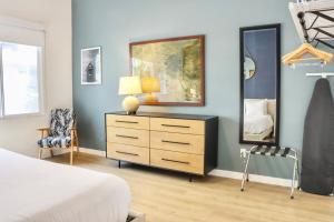Un dormitorio con una cama, una cómoda y un espejo. en Ambient Oasis In The Heart Of San Diego, en San Diego