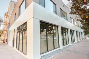 a building with large windows on a city street at Cozy Couple's Corner In Downtown San Diego in San Diego