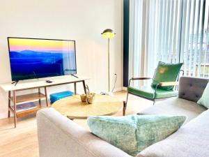 a living room with a couch and a television at The Leo - Unit 602 in San Diego