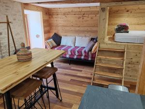 a living room with a couch and a table at La petite étoile d'hôtes en Mercantour in Saint-Dalmas-le-Selvage