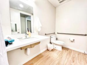a bathroom with a sink and a toilet at The Leo - One Bedroom Apartment W Private Balcony in San Diego +16 photos