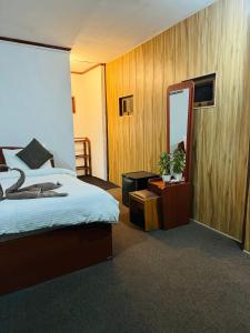 a bedroom with a bed and a large mirror at Will Guest Homestay in Ella