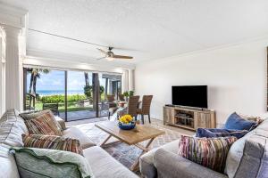 un soggiorno con un divano e una televisione di Beachfront Aldea 3 a Clearwater Beach