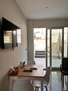 a dining room with a wooden table and chairs at IG - "Villa Don Antonio" Apartments in Giardini Naxos