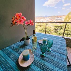 a table with a bottle of wine and flowers on it at Estrella Apartment in Sparta +7 photos