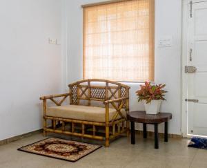 a room with a chair and a table and a window at Vega Paradise in Kanthalloor