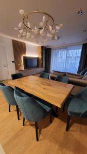 a conference room with a wooden table and chairs at K District apartment Belgrade - central BG, private parking in Belgrade