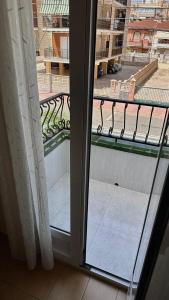 an open door to a balcony with a view at Bungalow Gaviota con playa y terraza in Santa Pola