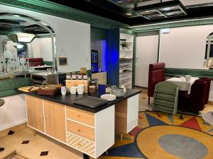 a kitchen with a counter and a table in a room at Hotel du Nord - Ville-Haute in Saint-Flour