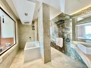 un bagno con lavandino, vasca e finestra di Gaia Pyramids View INN a Il Cairo