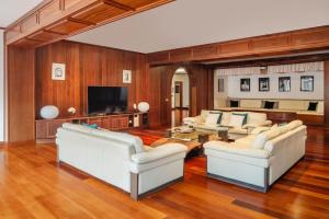 a living room with white couches and a television at TINDAYA by Buenavilla in Puerto Calero