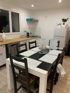 a kitchen with a table and chairs and a kitchen with a counter at la maison bel air in Limoux