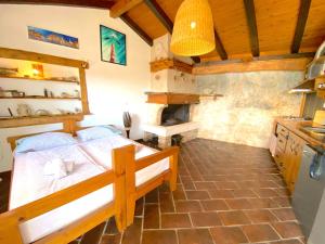 a bedroom with a bed and a kitchen with a stove at Apartments Villa Marcelina in Hvar +62 photos