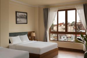 Voodi või voodid majutusasutuse Lumina Hotel Da Lat Central toas