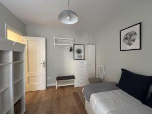a bedroom with a bed and a dresser and a closet at Loft in Uribarri in Bilbao