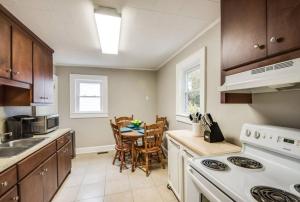 a kitchen with a table and a white stove top oven at Southern Charm Cottage in Hickory