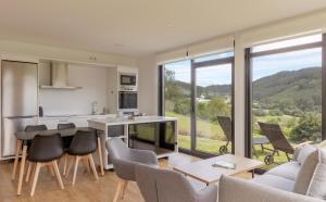 a kitchen and living room with a table and chairs at Casa Candales - Eladia in Cedeira