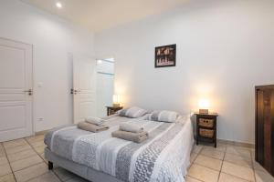 a bedroom with a large bed with towels on it at "Le Zen" by EnjoyNice, central spacious apartment with Airco, beach at 10 min in Nice