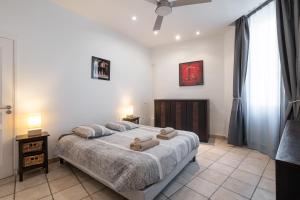 a bedroom with a bed with two towels on it at "Le Zen" by EnjoyNice, central spacious apartment with Airco, beach at 10 min in Nice