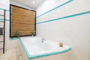 a bathroom with a tub and a window at "Le Zen" by EnjoyNice, central spacious apartment with Airco, beach at 10 min in Nice