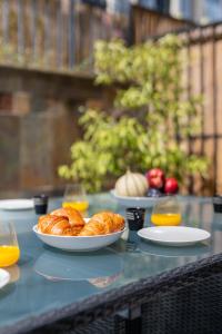 a table with two plates of croissants and orange juice at "Le Zen" by EnjoyNice, central spacious apartment with Airco, beach at 10 min in Nice