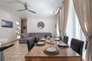 a dining room and living room with a table and chairs at "Le Zen" by EnjoyNice, central spacious apartment with Airco, beach at 10 min in Nice