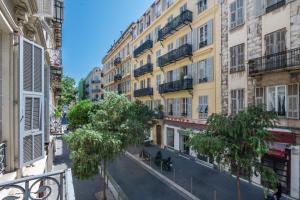 an empty street in a city with buildings at "Le Zen" by EnjoyNice, central spacious apartment with Airco, beach at 10 min in Nice