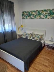 a bedroom with a bed with a black bedspread at Buddies Charm Apt - Self Catering in Aveiro