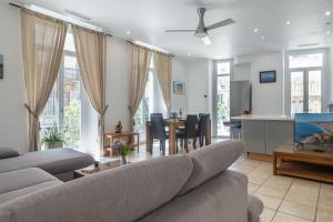 a living room with a couch and a table at "Le Zen" by EnjoyNice, central spacious apartment with Airco, beach at 10 min in Nice