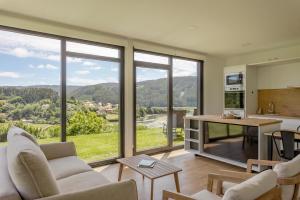 a living room with a view of a kitchen at Casa Candales - Consuelo in Cedeira