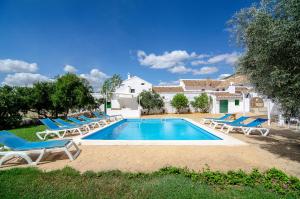 a swimming pool with lounge chairs and a house at Cortijo Alzamigaja in Archidona