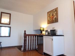 a room with a staircase with a microwave on a counter at Casa Al-Hammam in Baños de la Encina +44 photos