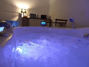 a tub filled with blue water in a room at Casa Al-Hammam in Baños de la Encina