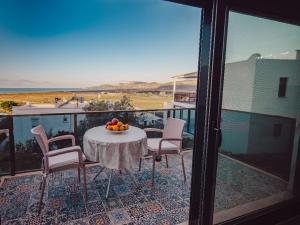 a table with a bowl of fruit on a balcony at SUNSET AİRPORT VİLLA in Dalaman