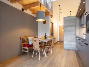 a kitchen and dining room with a table and chairs at Apart33 Top 2-16 in Haus im Ennstal