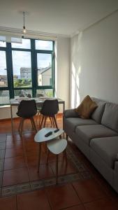 a living room with a couch and a table with chairs at Refugio de mar in Barreiros