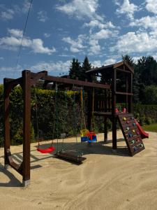 a playground with swings and a play structure at Park Zastawie in Kielce