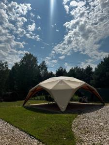a tent sitting on the grass in a field at Park Zastawie in Kielce