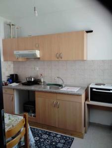 a kitchen with a sink and a microwave at Niki rooms in Samothraki