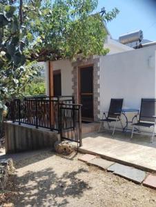 a house with two chairs sitting on a patio at Niki rooms in Samothraki +6 photos
