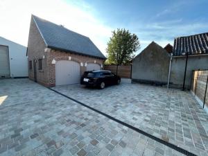a car parked in front of a brick house at Duivenboshuisje in Herzele