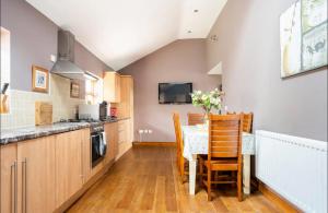 a kitchen with a table and some chairs in a room at Bogma Cottages in Durham