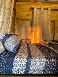 Ένα ή περισσότερα κρεβάτια σε δωμάτιο στο ไร่ณัฐลิษา โฮมสเตย์