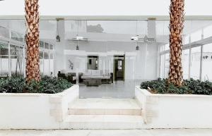 a lobby with two palm trees in a building at Luxe Living Spacious Retreat Torre Real Ii in Santiago de los Caballeros