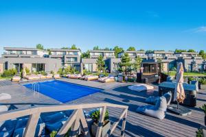 a resort with a swimming pool and some buildings at SUN HOME in Palanga