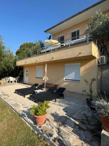 a building with a group of benches in front of it at Apartman Sofija HN in Herceg-Novi +14 photos